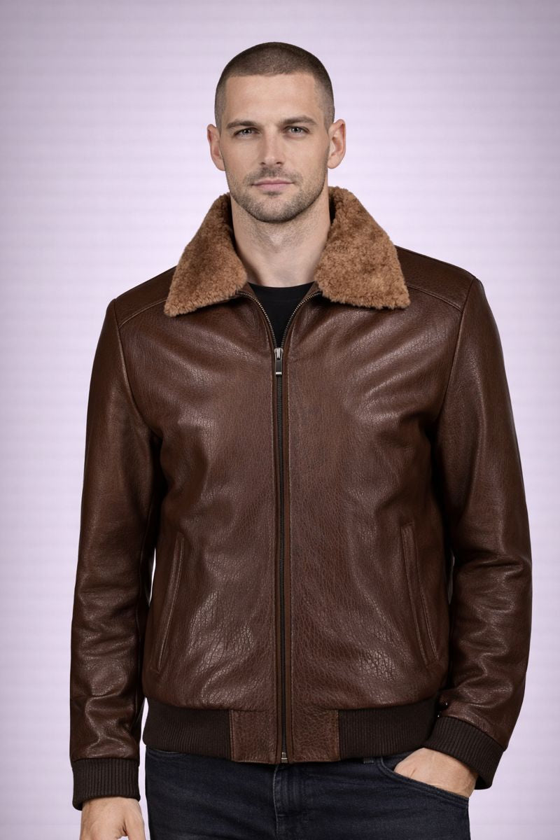 Man wearing a brown leather jacket with fur collar on a light purple background