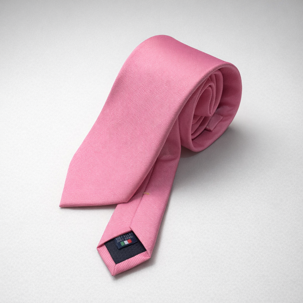 Pink silk Ascot tie on a grey background.