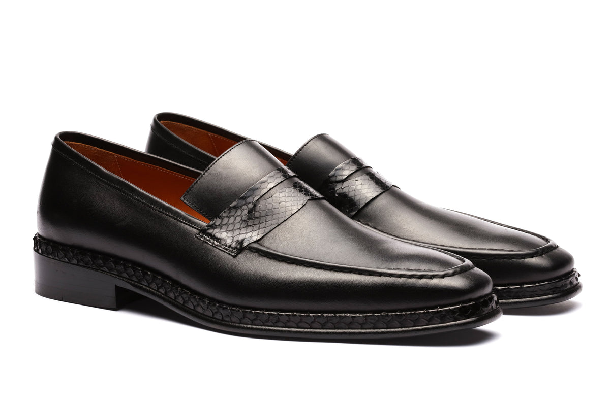 URBBANA black python-skin penny loafers.