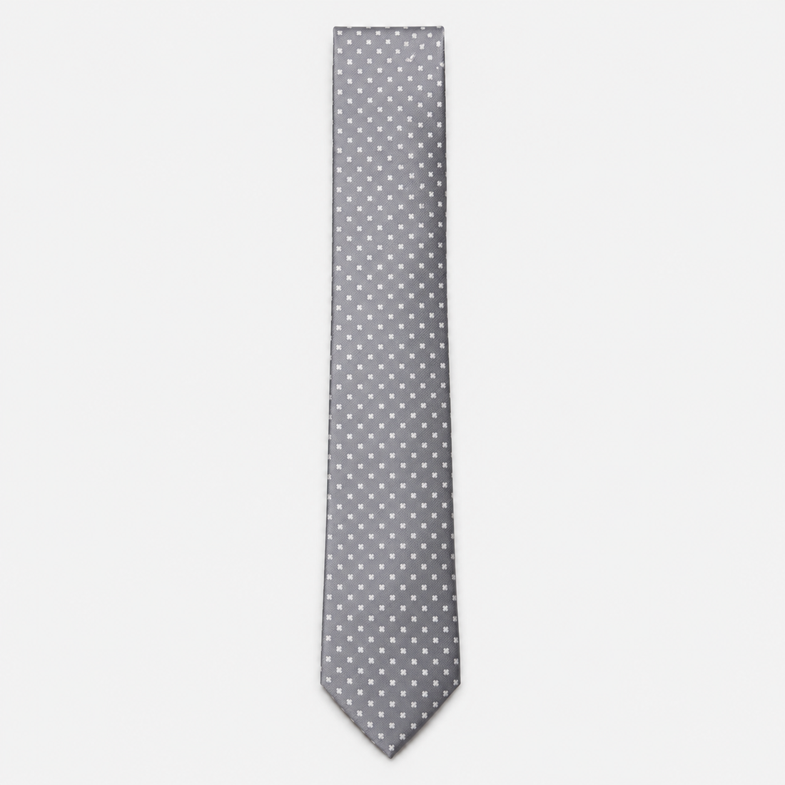 The Cosenza Tie – silver grey and white polka dot silk tie on a light grey background