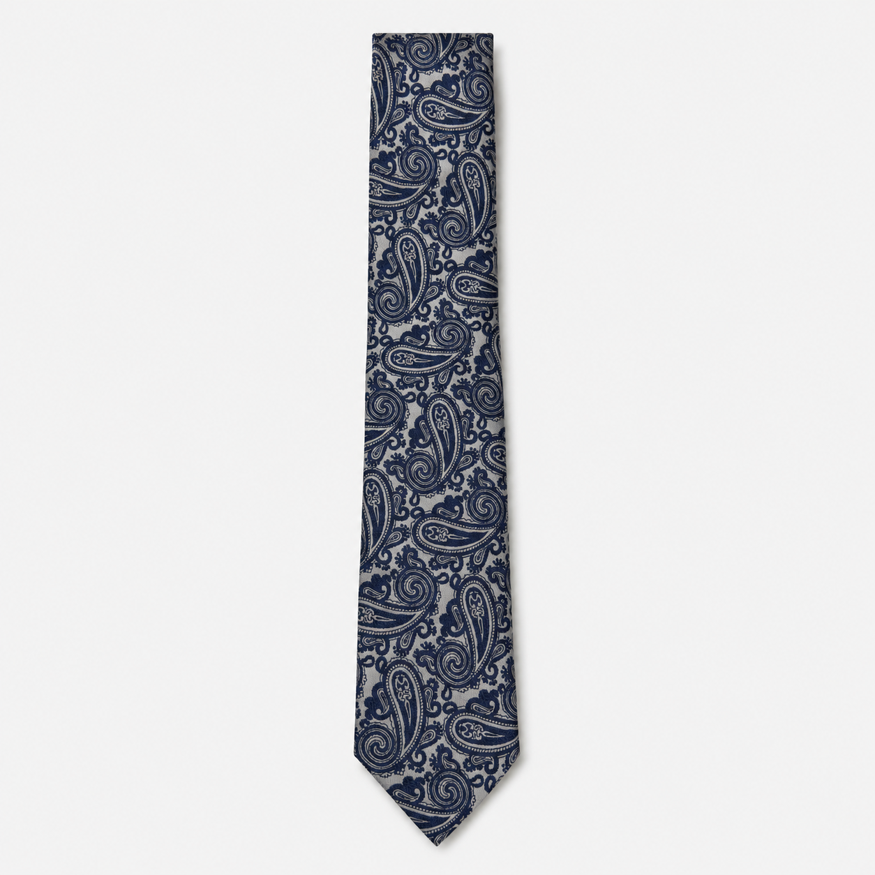 The Grosseto Tie – navy and silver paisley silk tie on a light grey background