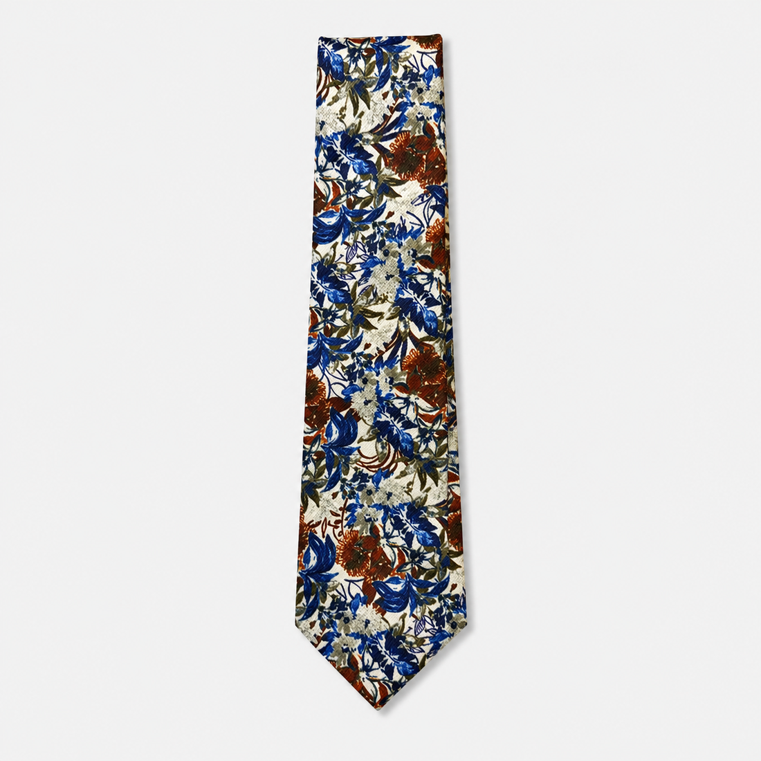 The Matera Tie, an ivory silk tie with navy blue, rust and olive botanical motifs on a light grey background.