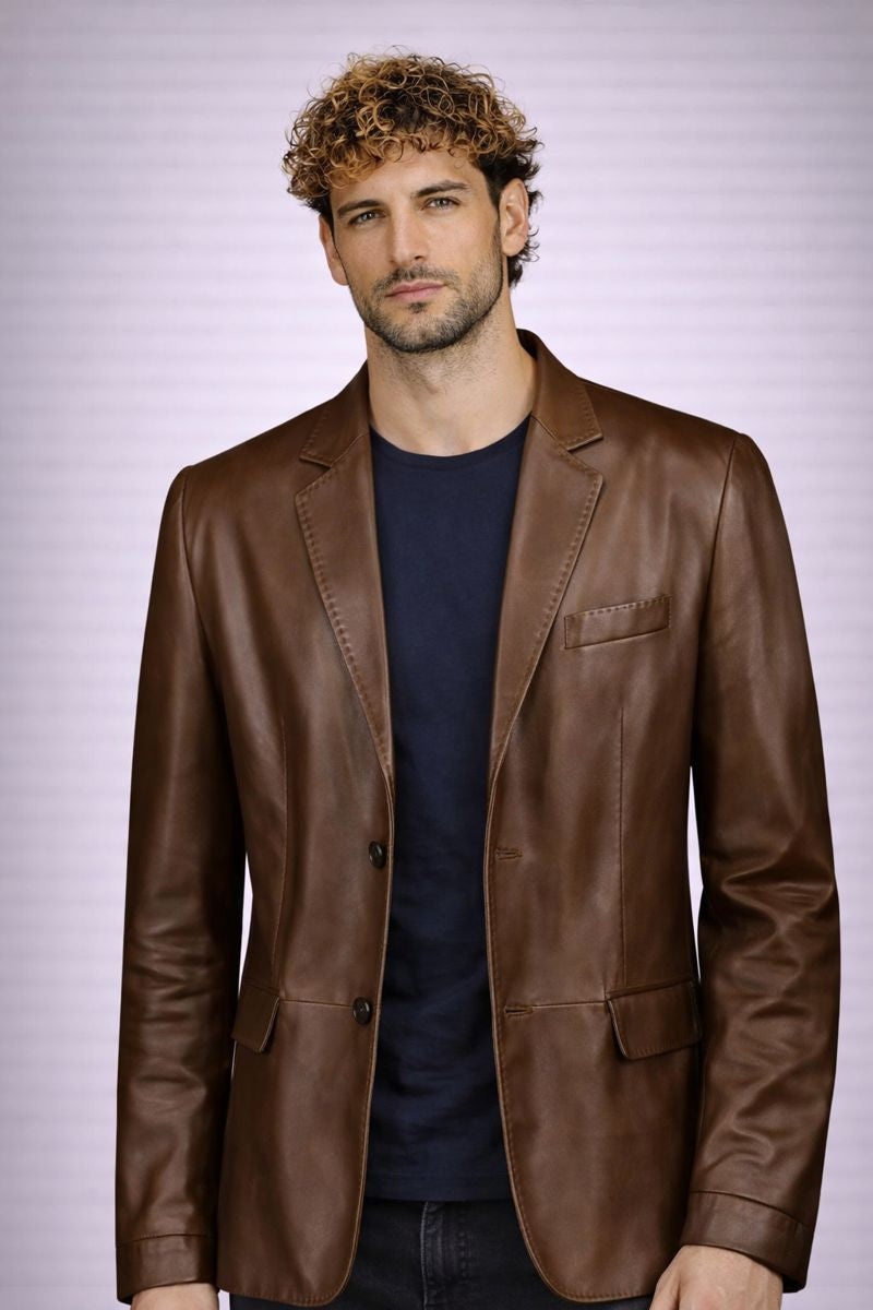 Man wearing a brown leather jacket against a light purple background