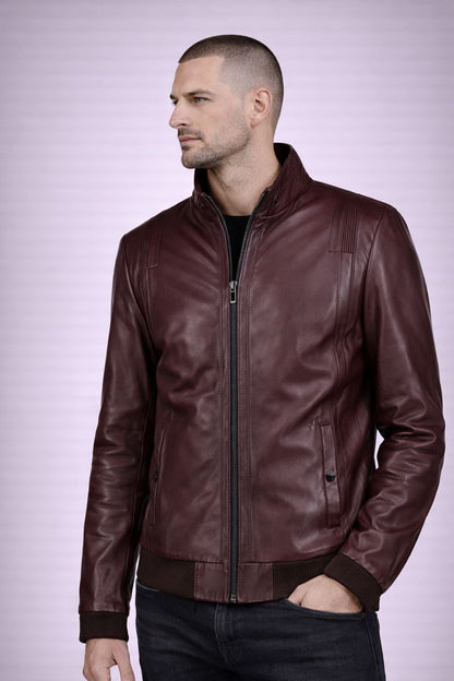 Man wearing a brown leather jacket on a light purple background