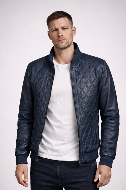 Man wearing a dark blue quilted leather jacket on a white background