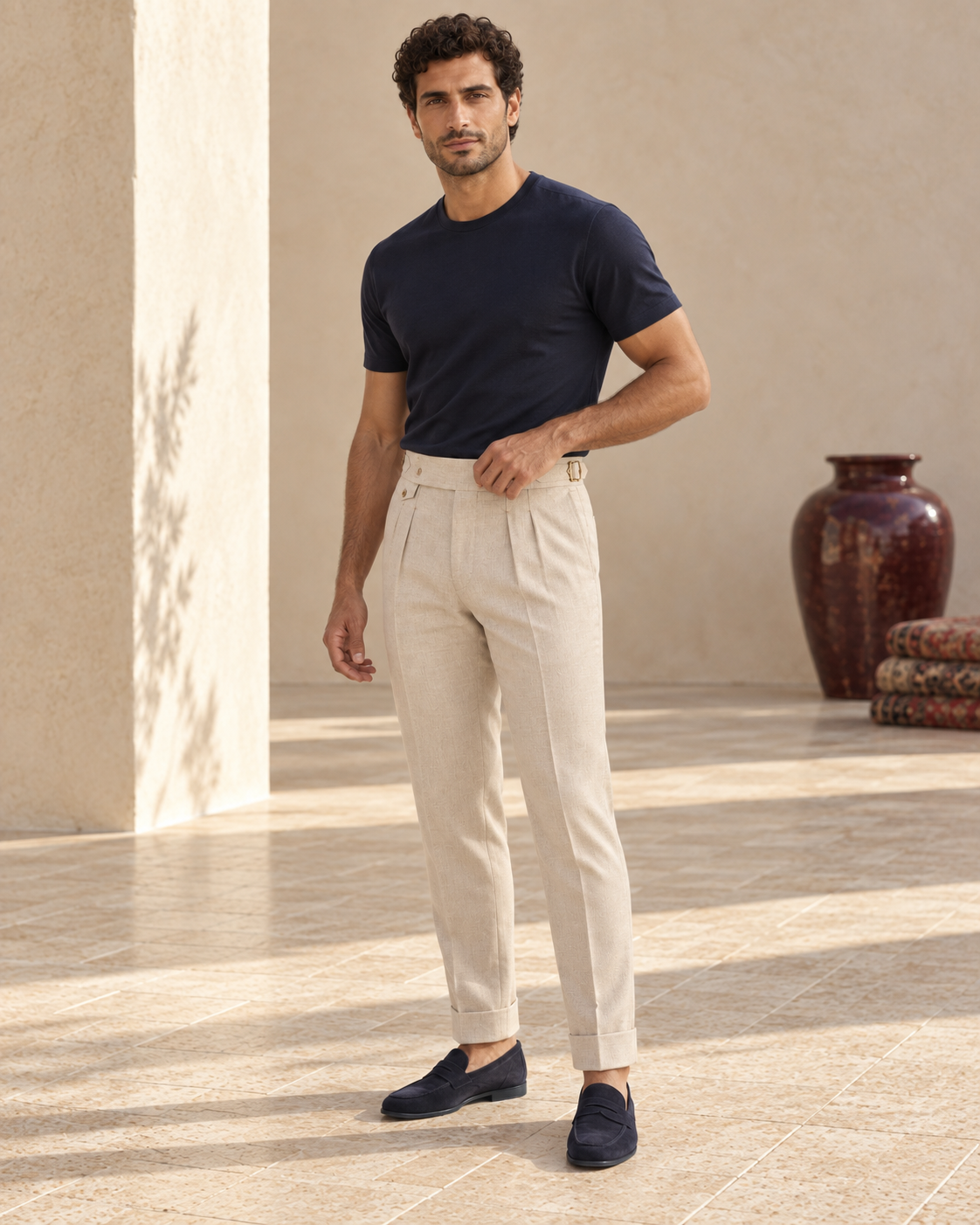 Model wearing Byron Trousers Sand with navy T-shirt