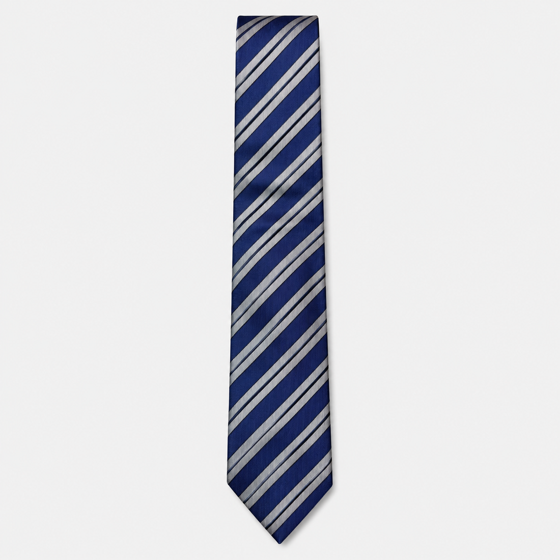 The Ancona Tie – navy, light blue and silver diagonal stripe silk tie on a light grey background