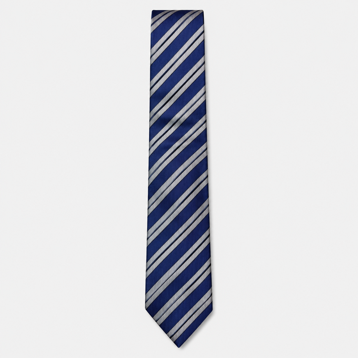 The Ancona Tie – navy, light blue and silver diagonal stripe silk tie on a light grey background