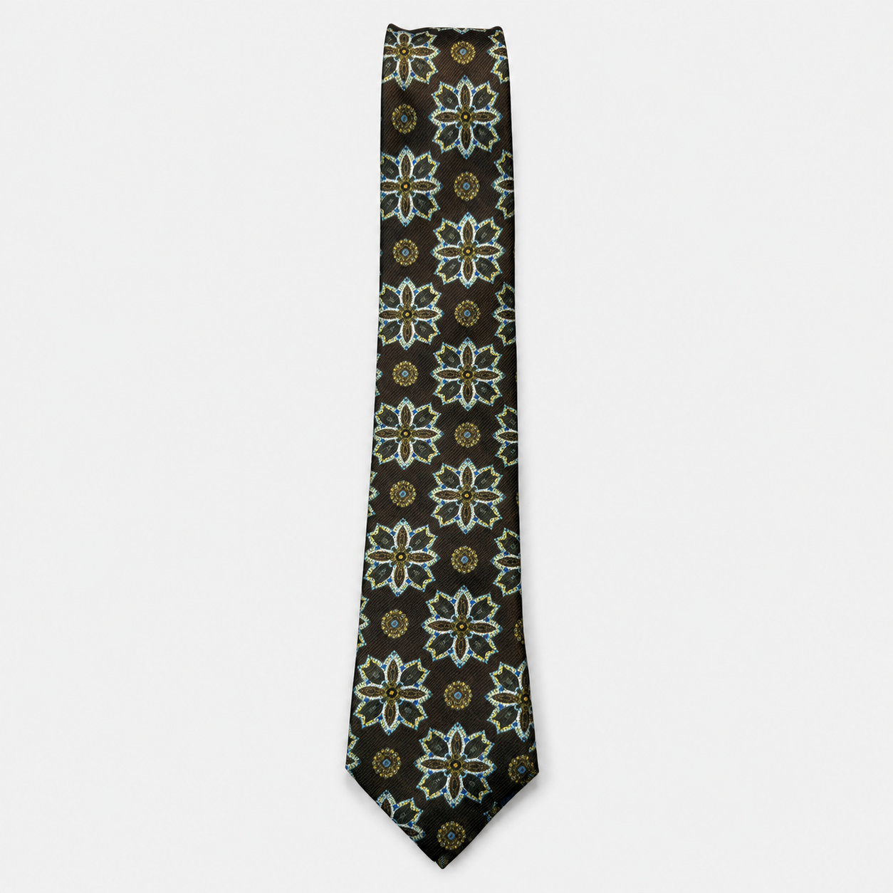 The Asti Tie – black, teal and ivory floral medallion silk tie on a light grey background