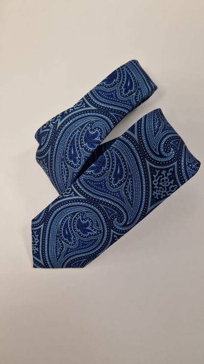 Blue tonal paisley silk tie, loosely folded.