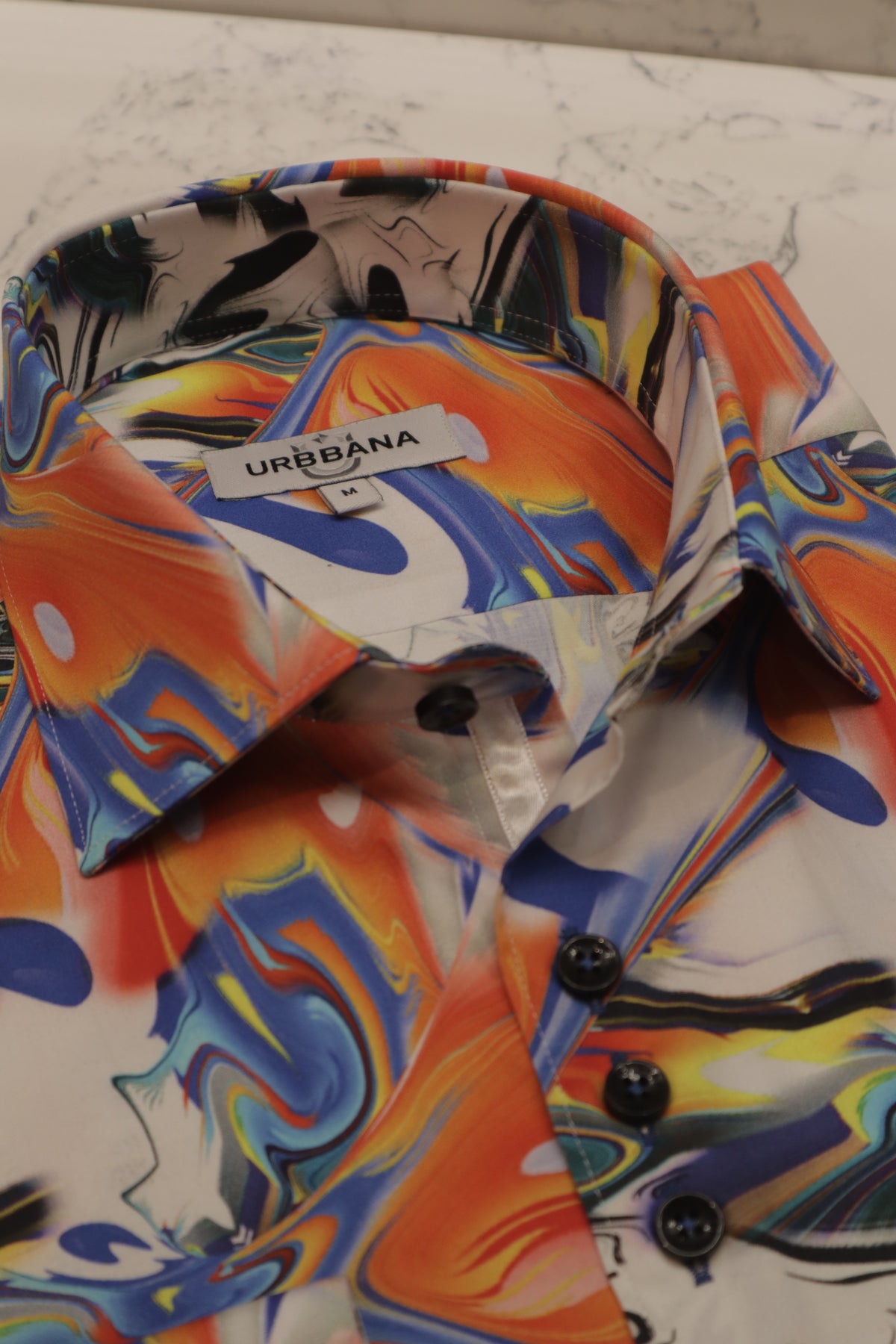 URBBANA light-colored shirt with bright splash print.