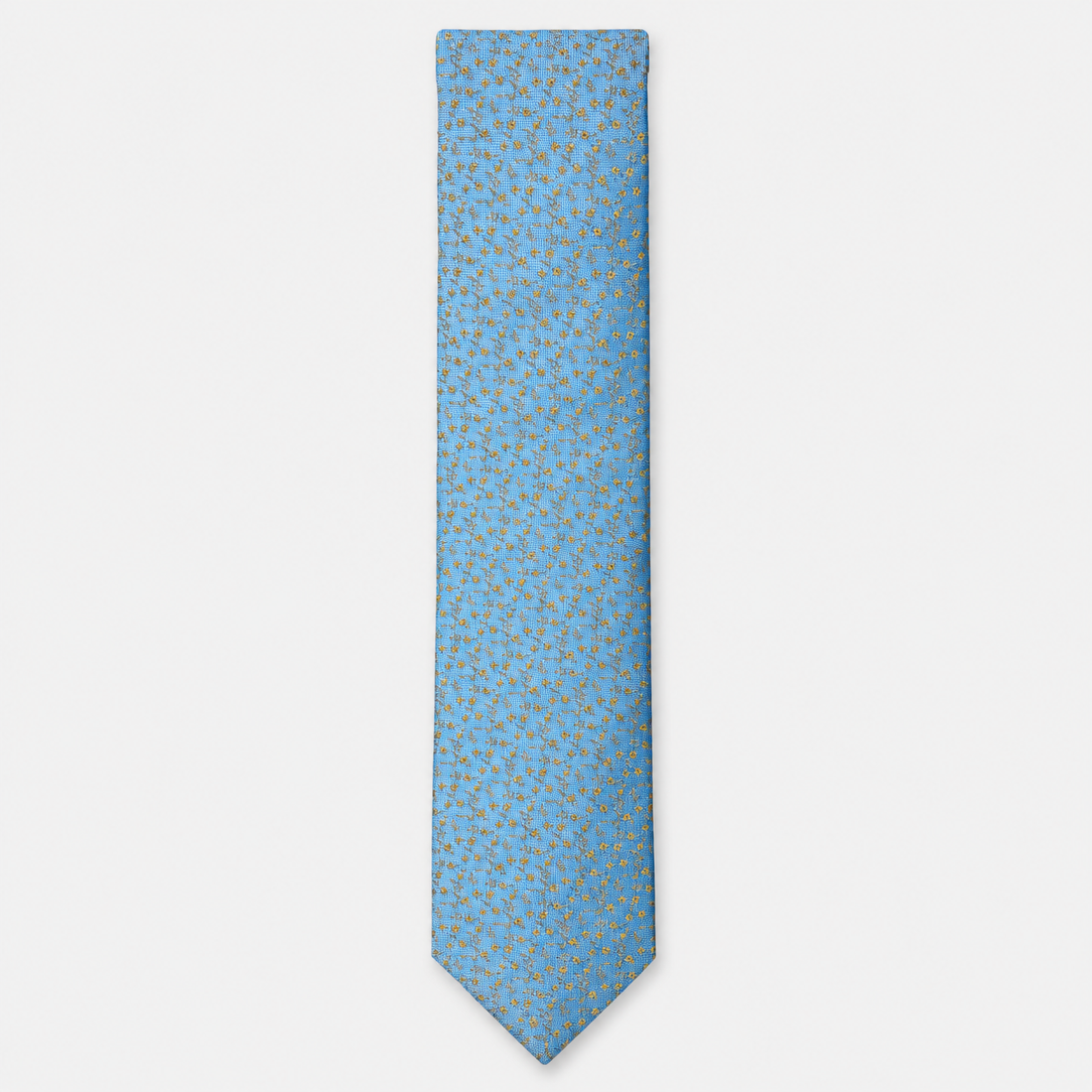 The Brindisi Tie – sky blue and gold micro ornamental silk tie on a light grey background