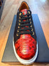 Brown and red exotic leather low-top sneaker with a white sole.