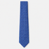 The Catania Tie, a blue silk tie with navy, light blue and gold square motifs on a light grey background.