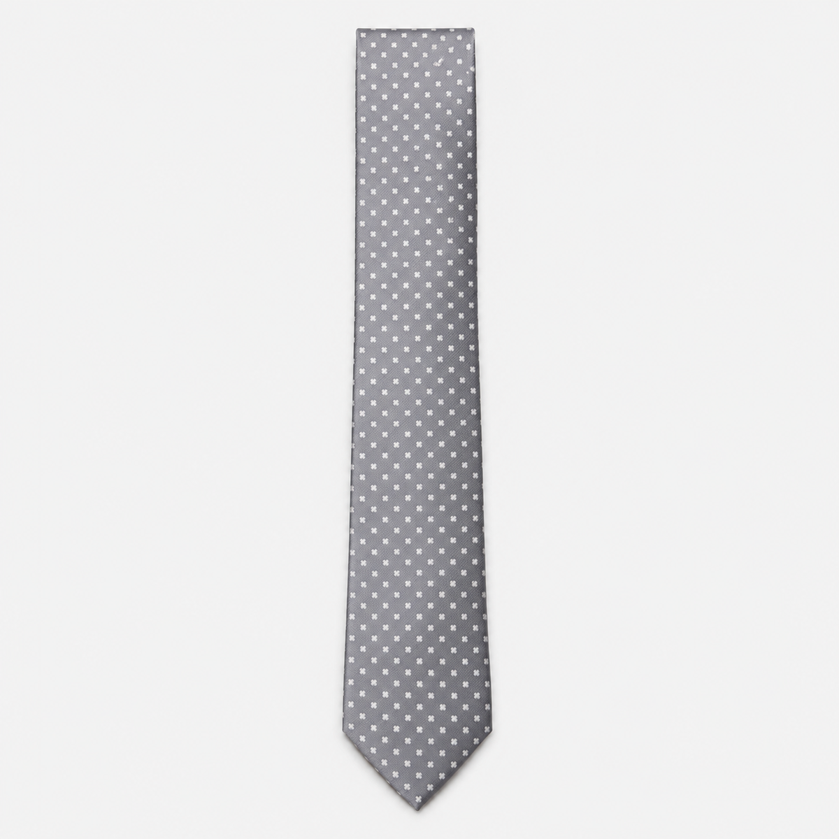 The Cosenza Tie – silver grey and white polka dot silk tie on a light grey background