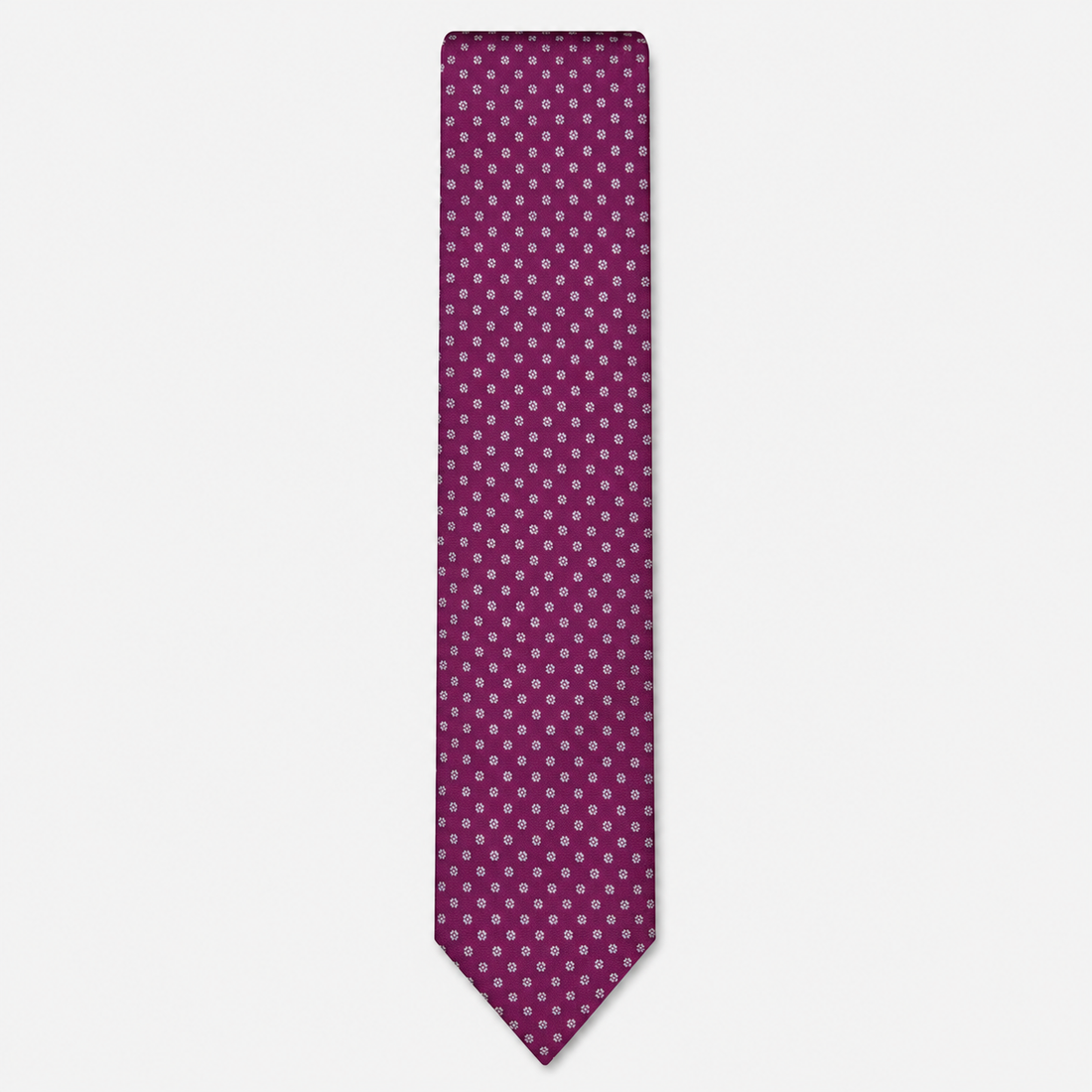 The Cremona Tie – magenta and white micro dot silk tie on a light grey background