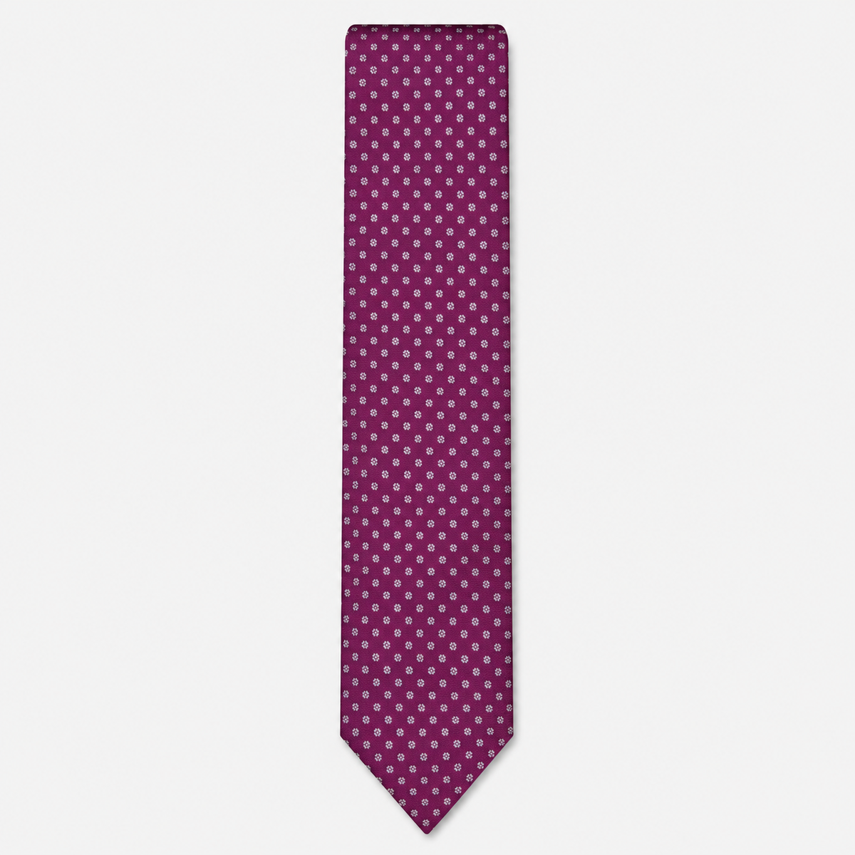 The Cremona Tie – magenta and white micro dot silk tie on a light grey background