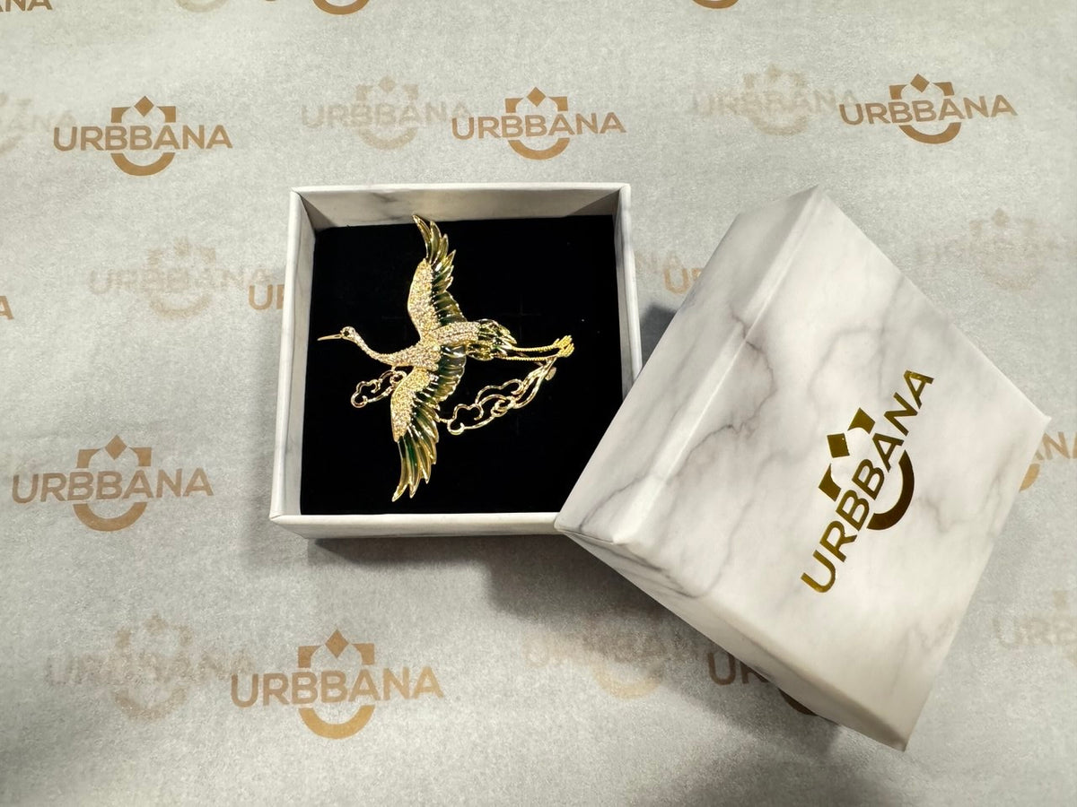 Gold-tone flying crane lapel pin.