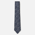 The Grosseto Tie – navy and silver paisley silk tie on a light grey background