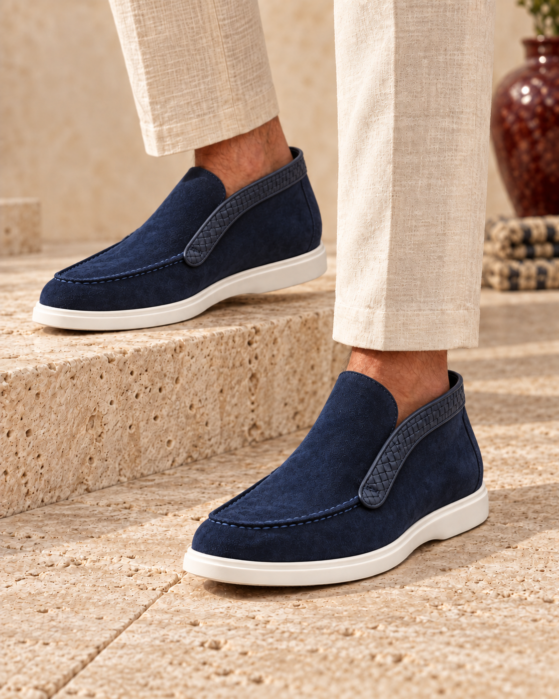 URBBANA Caspian Blue ankle loafers worn with linen trousers on limestone steps.