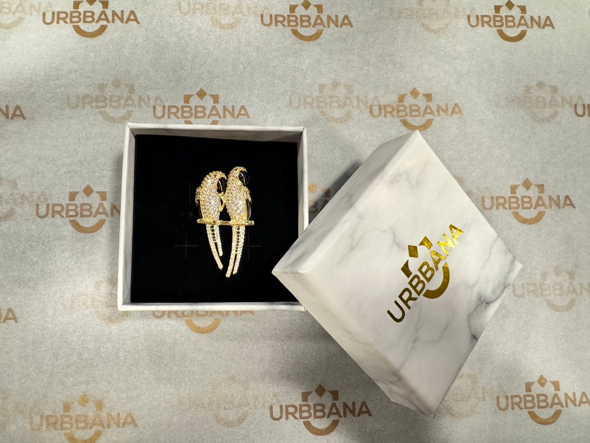 Parrot-shaped lapel pin with intricate detailing.