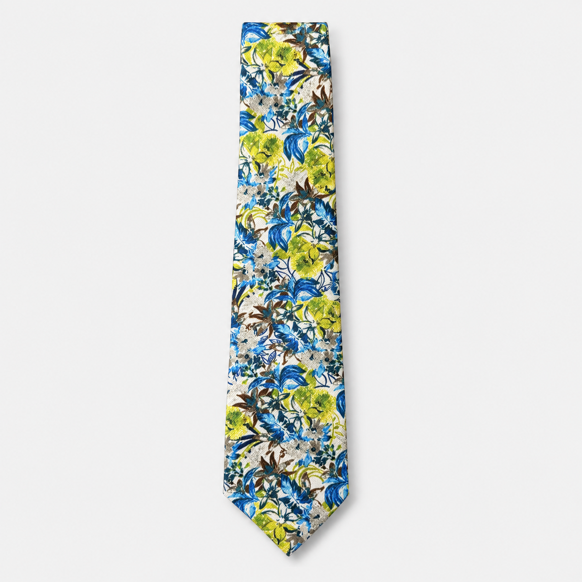 The Perugia Tie, an ivory silk tie with bright blue, lime green and brown botanical motifs on a light grey background.