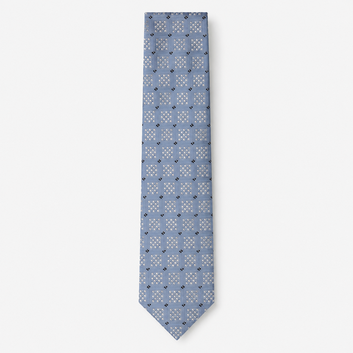 The Positano Tie, a light blue silk tie with white geometric checks and navy accents on a light grey background.