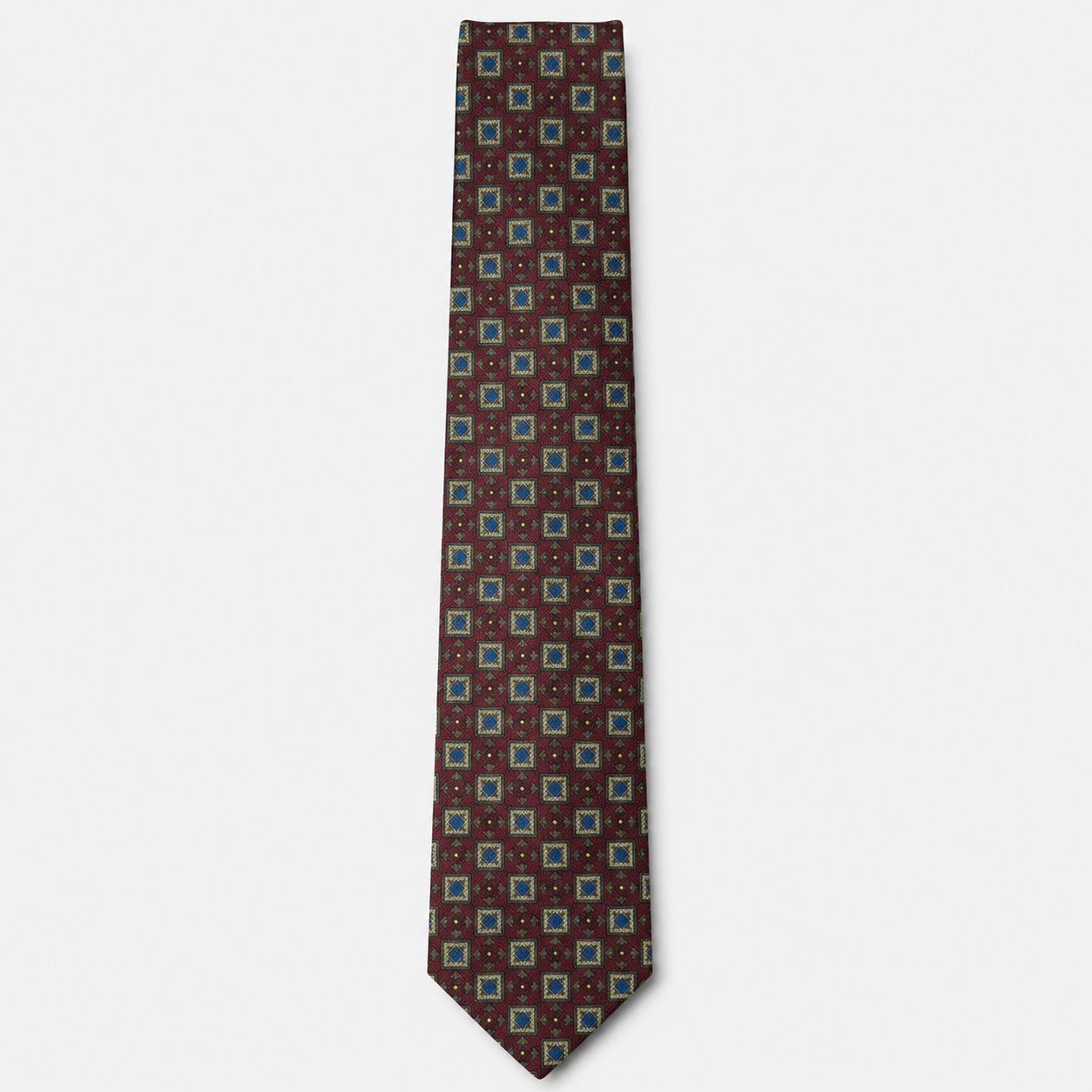 The Rimini Tie – brown, turquoise and red geometric square silk tie on a light grey background