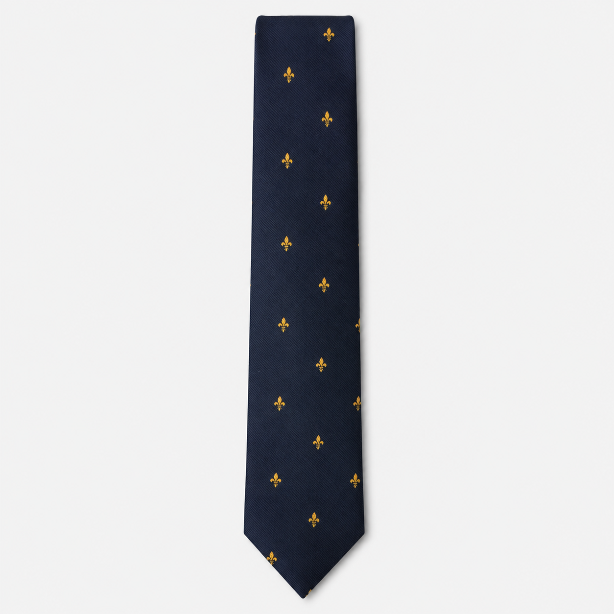 The Salerno Tie – navy and gold fleur-de-lis silk tie on a light grey background