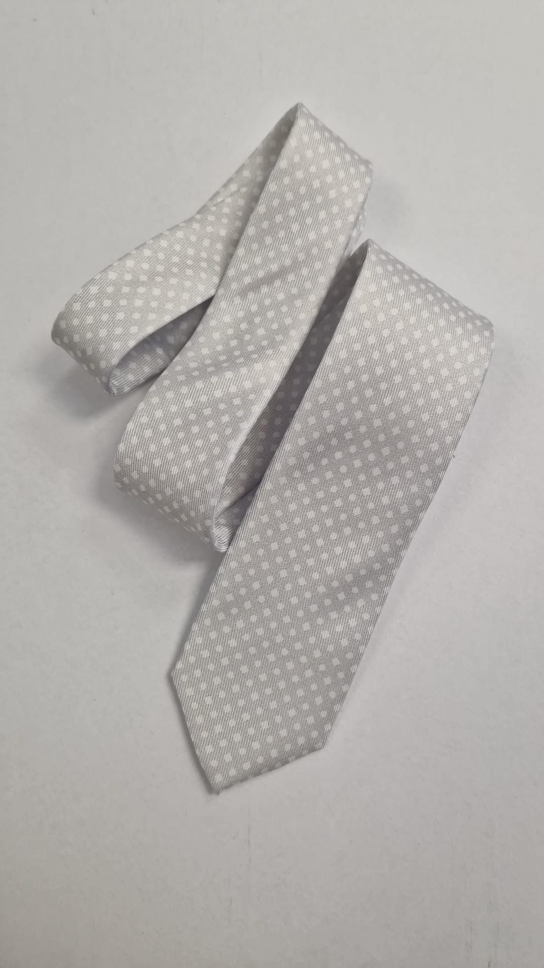 Silver silk tie with a subtle white dot pattern, loosely folded.