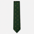 The Varese Tie – forest green and gold fleur-de-lis silk tie on a light grey background