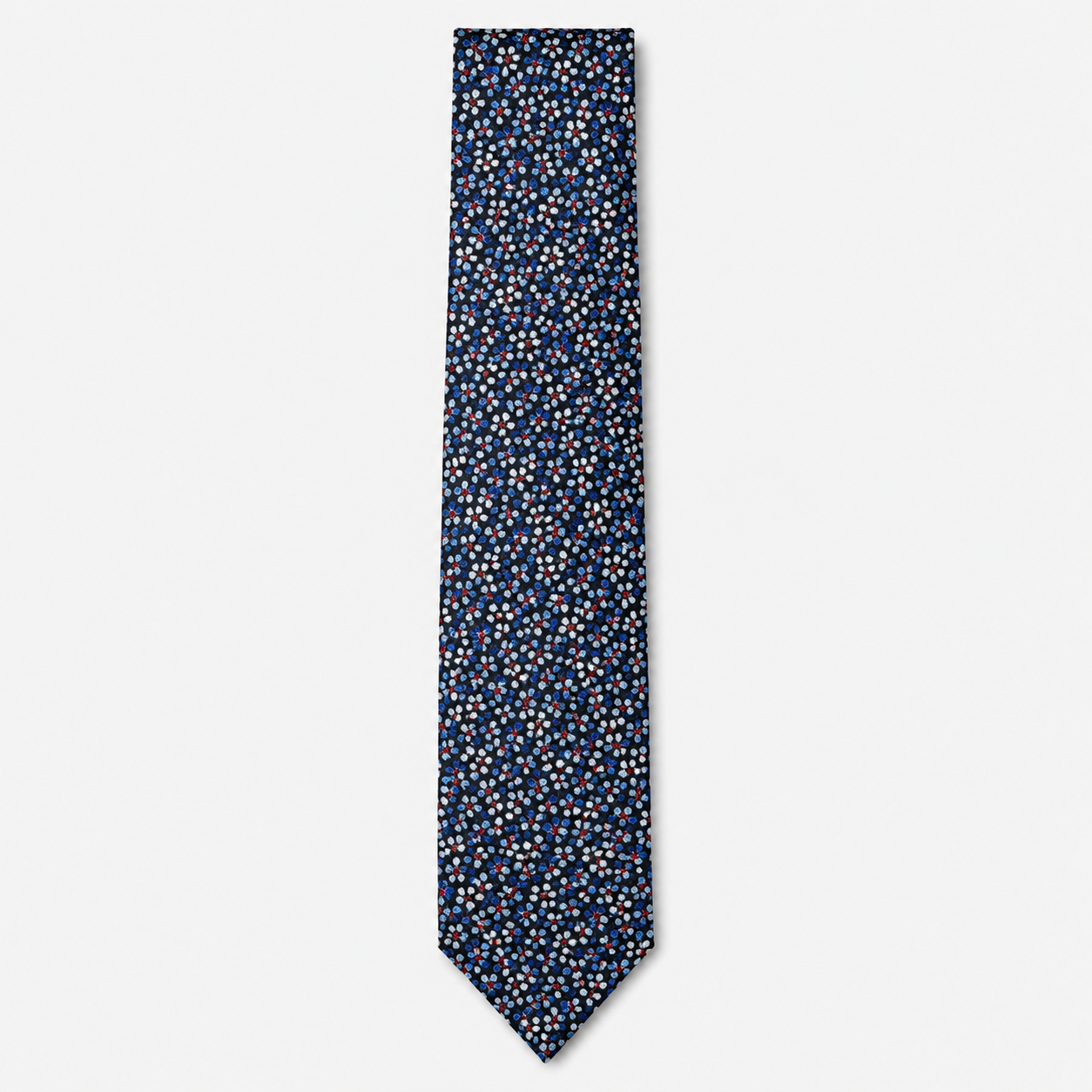 The Vicenza Tie, a navy silk tie with tiny light blue, white and red floral motifs on a light grey background.