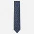The Vicenza Tie, a navy silk tie with tiny light blue, white and red floral motifs on a light grey background.