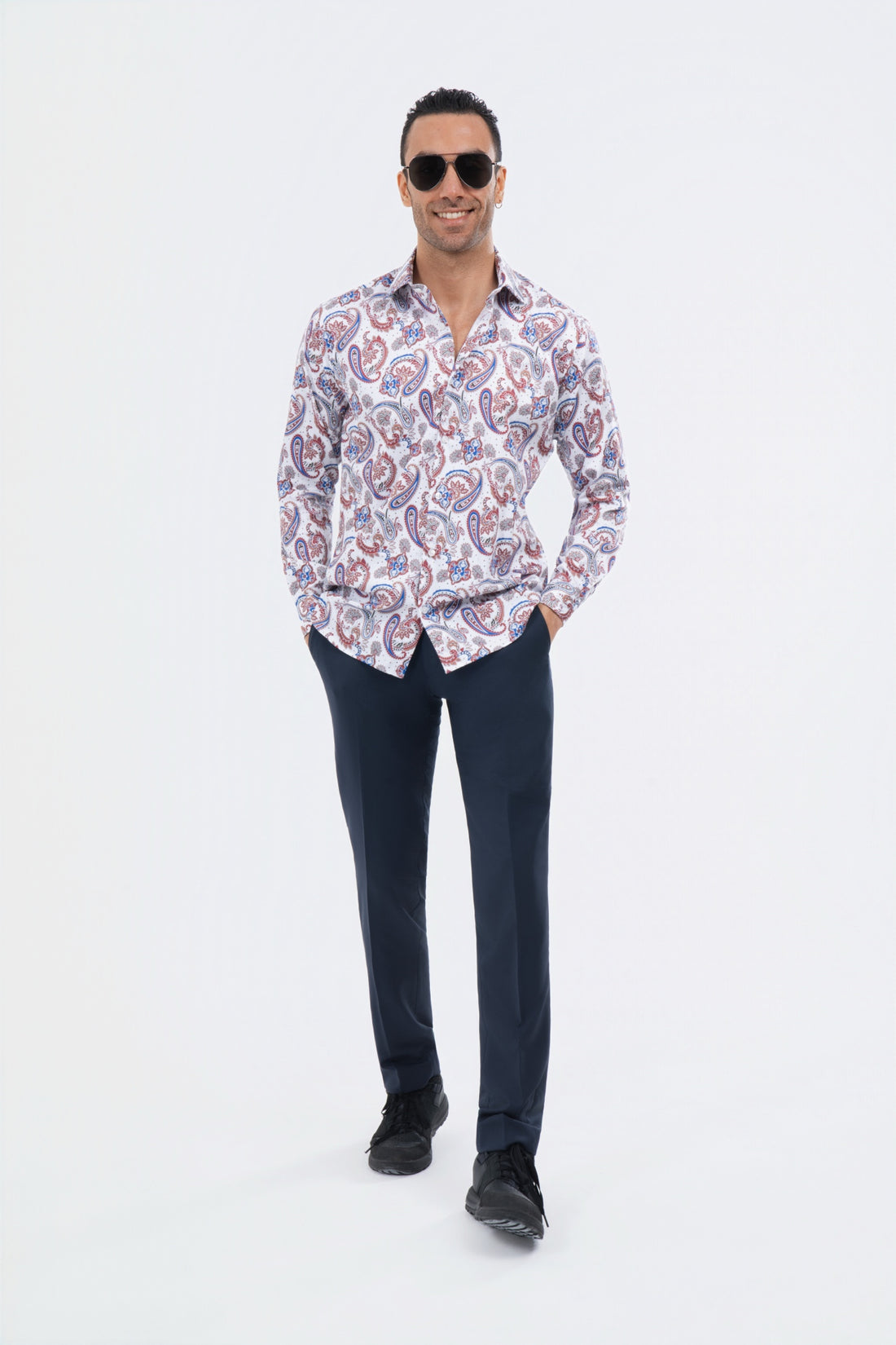 Male model wearing a white and lavender paisley shirt with black trousers.